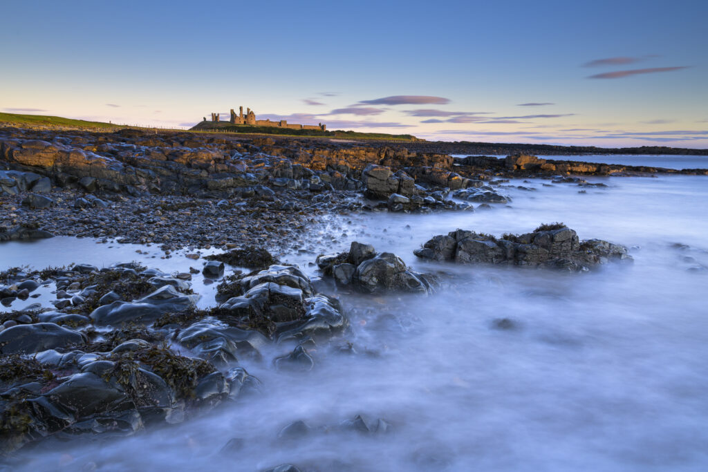 England, Northumberland, Dunstanburgh Castle. Dunstanburgh Castle at dawn, located along the Northumberland Heritage Coast.