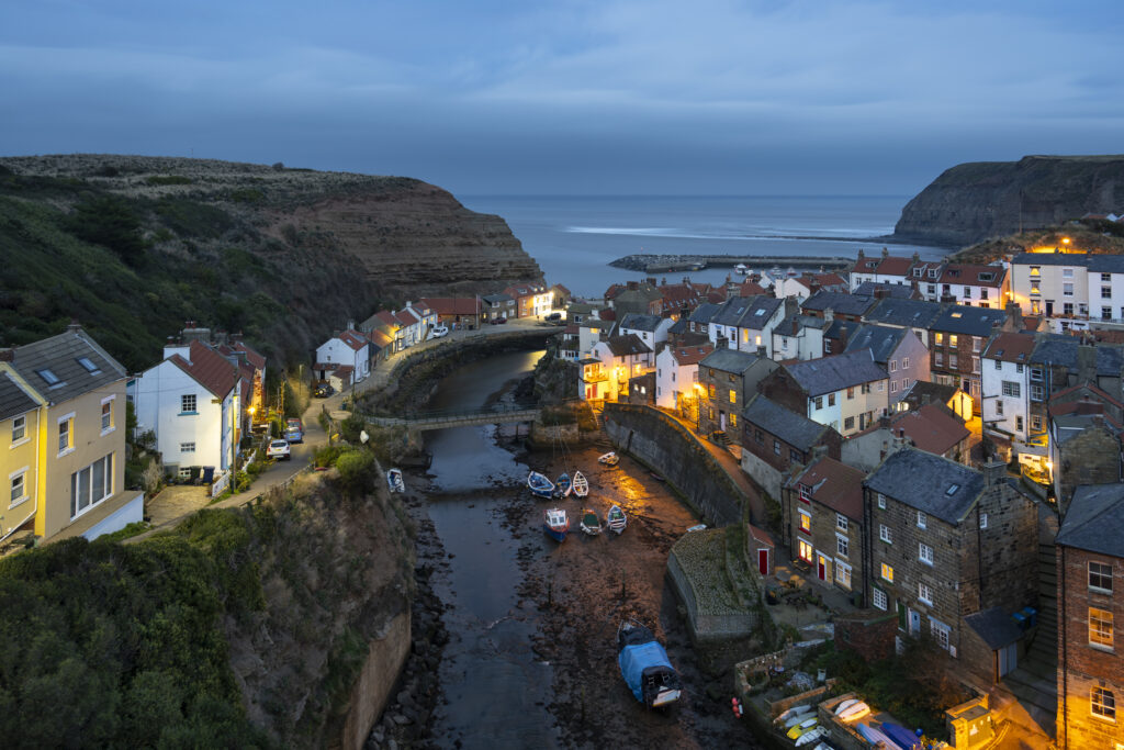England, North Yorkshire, North York Moors National Park. Dusk at the coastal village of Staithes, in the North York Moors National Park.