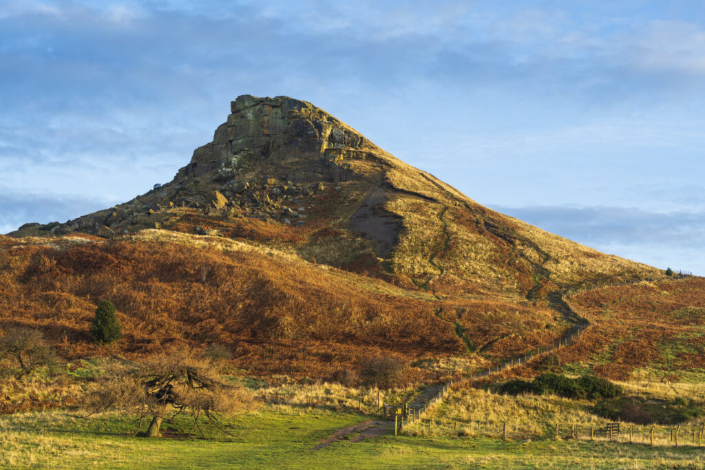 England, North Yorkshire, North York Moors National Park. Early morning light illuminates the distinctive peak of Roseberry Topping.