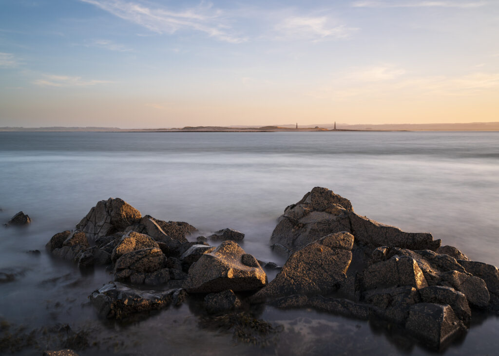 England, Northumberland, Holy Island of Lindisfarne. Looking from Lindisfarne at sunset twowards the Northumberland mainland.