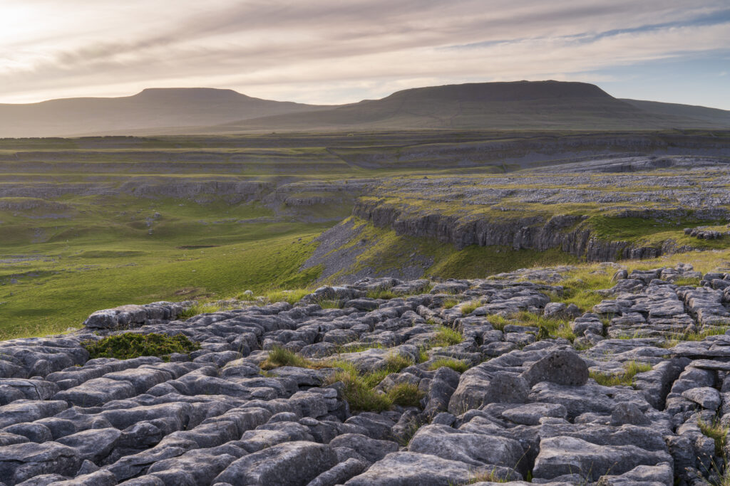 England, North Yorkshire, Yorkshire Dales National Park. Looking towards the peak of Ingleborough and the Moughton Scars, a natural karst landform (limestone pavement) which is common in the Yorkshire Dales.