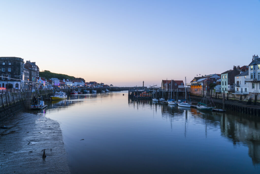 England, North Yorkshire, Whitby. Dusk on the banks of the River Esk in the popular town of Whitby.