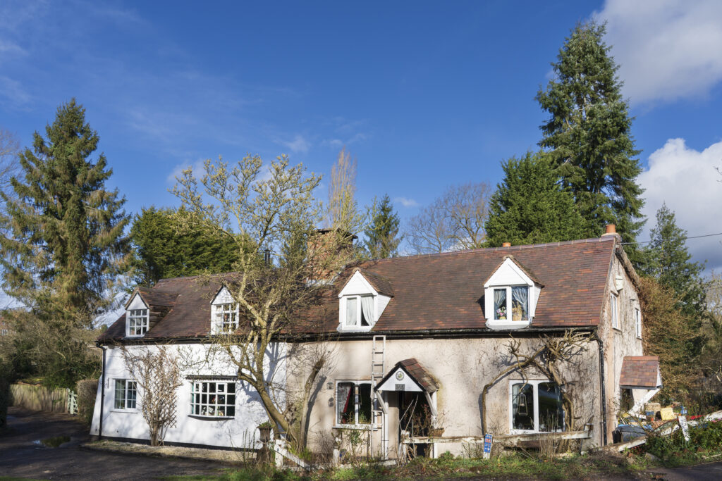 England, West Midlands, Kinver. Stone cottage and trees on the Staffordshire and Worcestershire Canal near Kinver