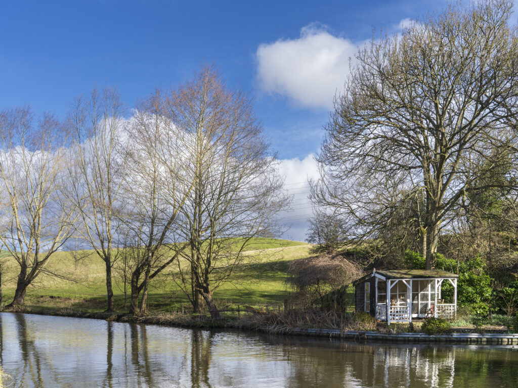 England, West Midlands, Kinver. Summerhouse and trees on the Staffordshire and Worcestershire Canal near Kinver