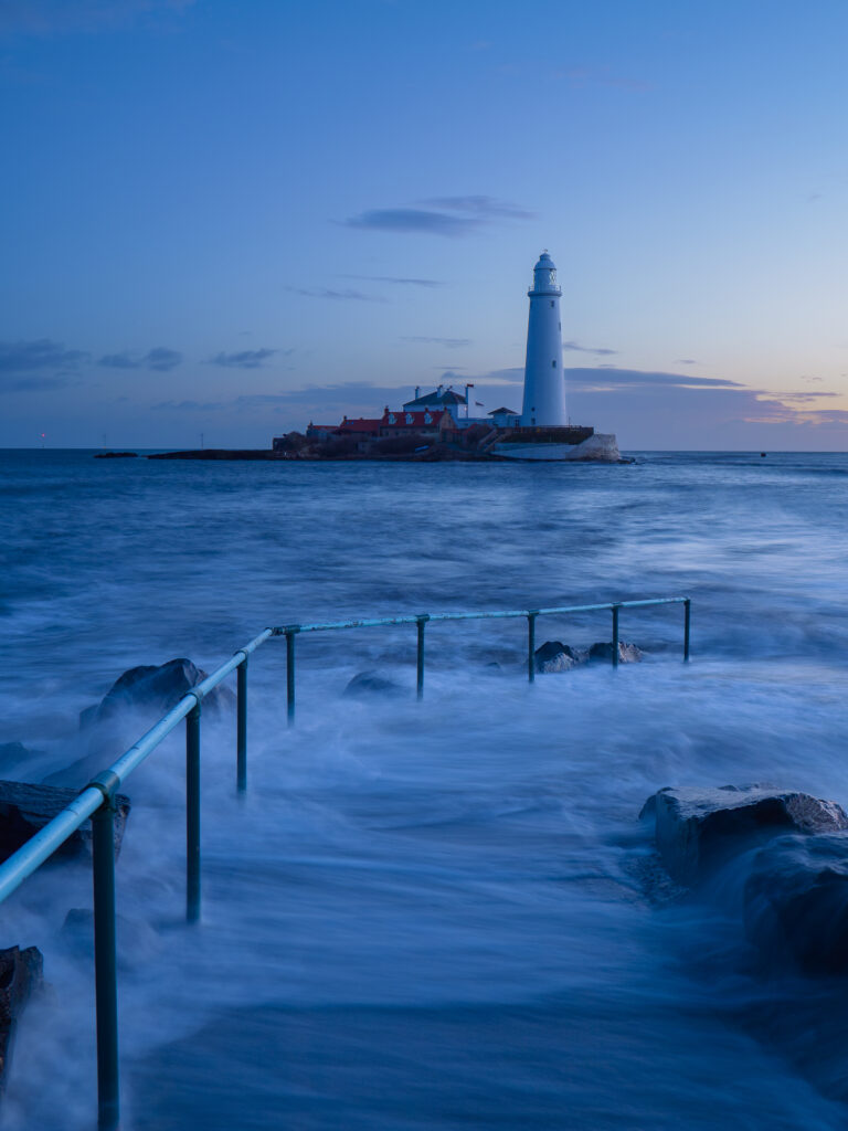 England, Tyne and Wear, St Mary's Island. Pre-dawn at high tide with the north sea covering the causeway to St Mary's Island and lighthouse, a popular location near Whitley Bay.