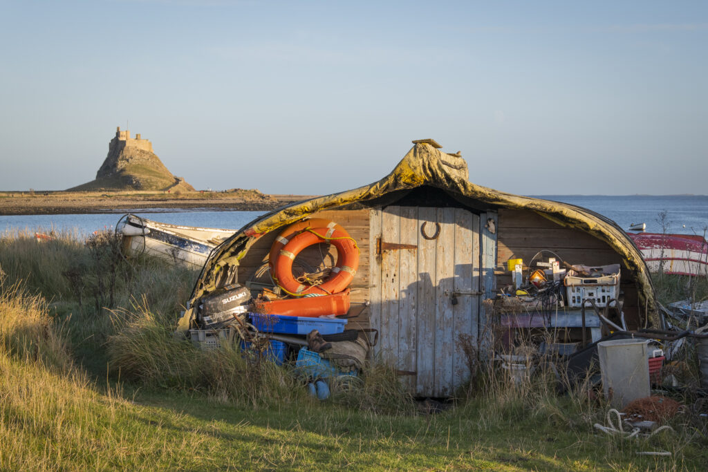 England, Northumberland, Lindisfarne / Holy Island. Upturned boat converted into a fishing hut on the Holy Island of Lindisfarne.