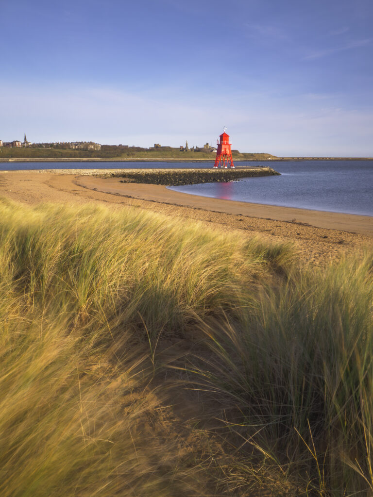 England, Tyne & Wear, South Shields. Little Haven Beach, looking towards the South Groyne Lighthouse.