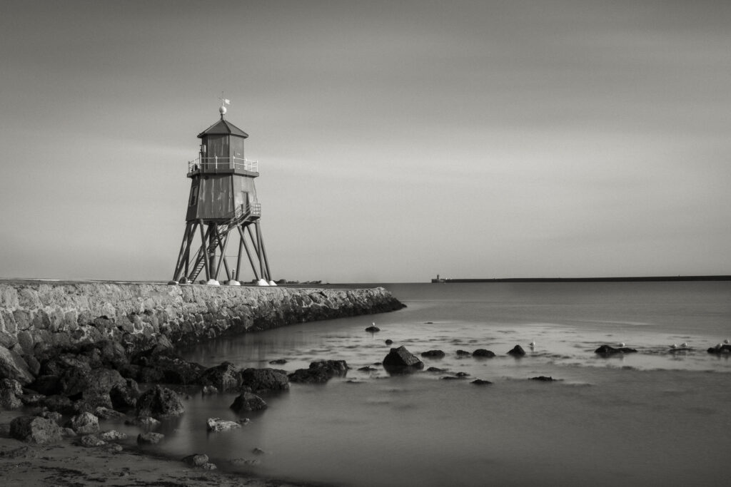 England, Tyne & Wear, South Shields. Little Haven Beach, looking towards the South Groyne Lighthouse.