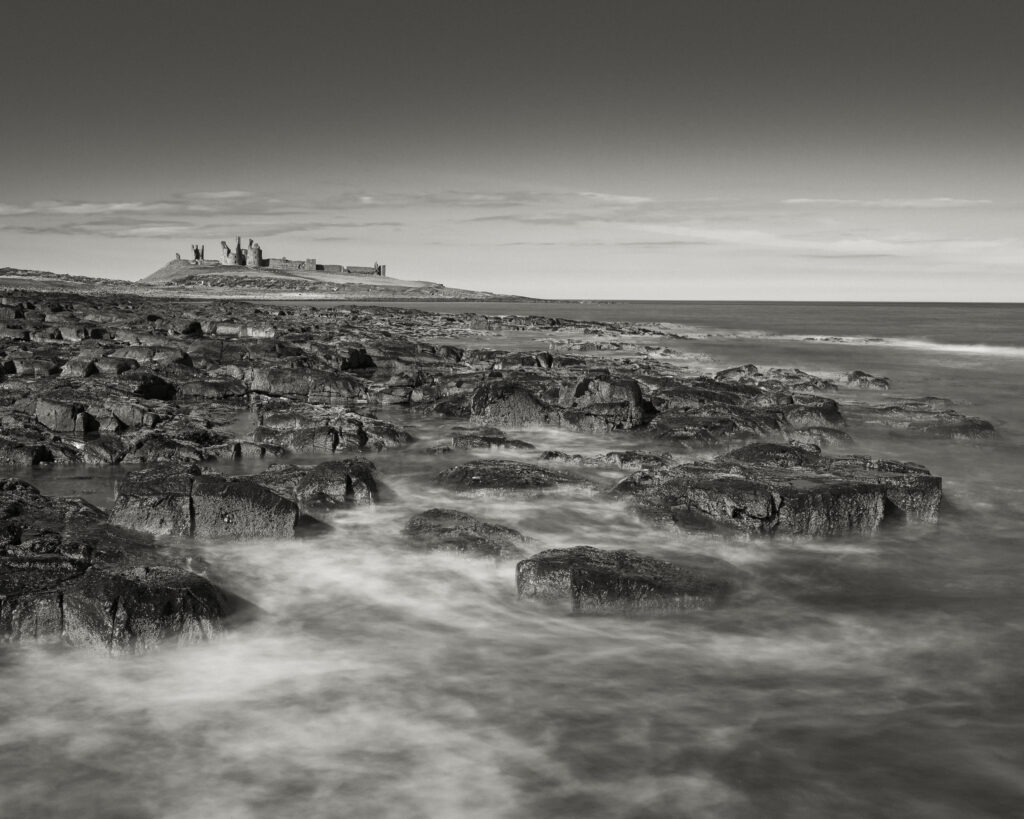 England, Northumberland, Dunstanburgh Castle. Dunstanburgh Castle viewed from near the village of Craster.