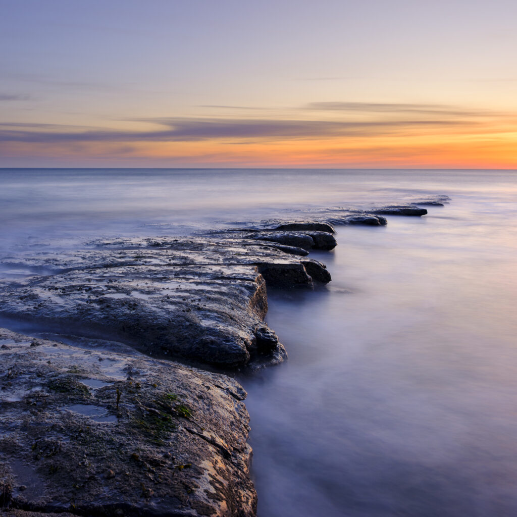 England, Northumberland, Cocklawburn Beach. The unique limestone geology of Cocklawburn Beach viewed at dawn.