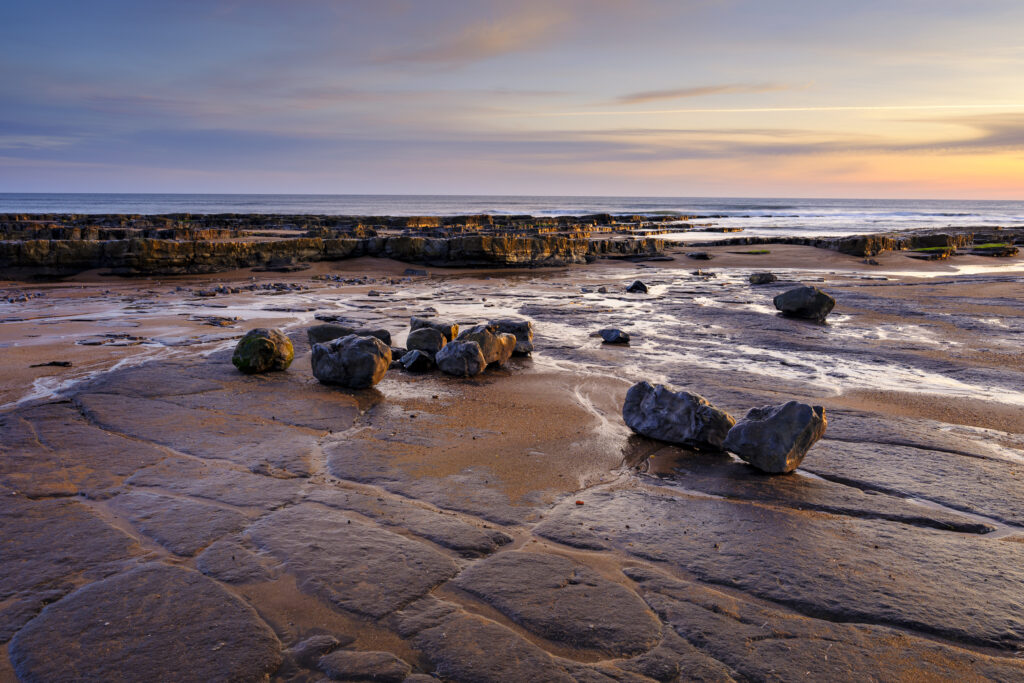 England, Northumberland, Cocklawburn Beach. The unique limestone geology of Cocklawburn Beach viewed at dawn.