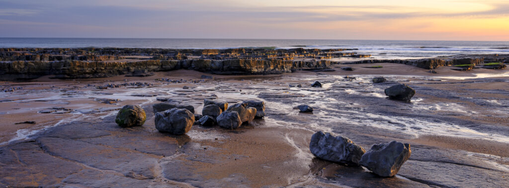 England, Northumberland, Cocklawburn Beach. The unique limestone geology of Cocklawburn Beach viewed at dawn.