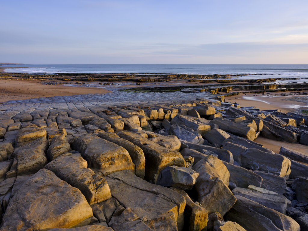 England, Northumberland, Cocklawburn Beach. The unique limestone geology of Cocklawburn Beach viewed at dawn.
