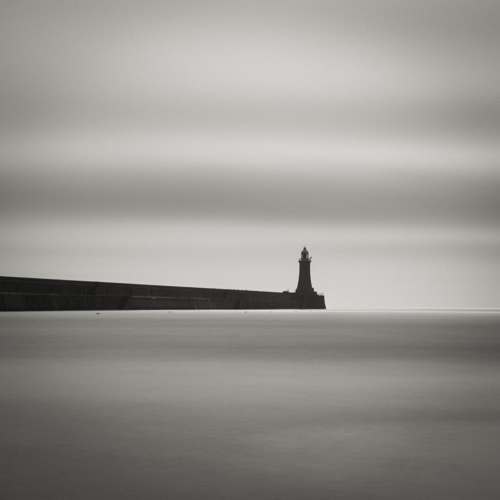 England, Tyne and Wear, Tynemouth. Black & White Long Exposure image of the lighthouse at Tynemouth Pier at the mouth of the River Tyne.