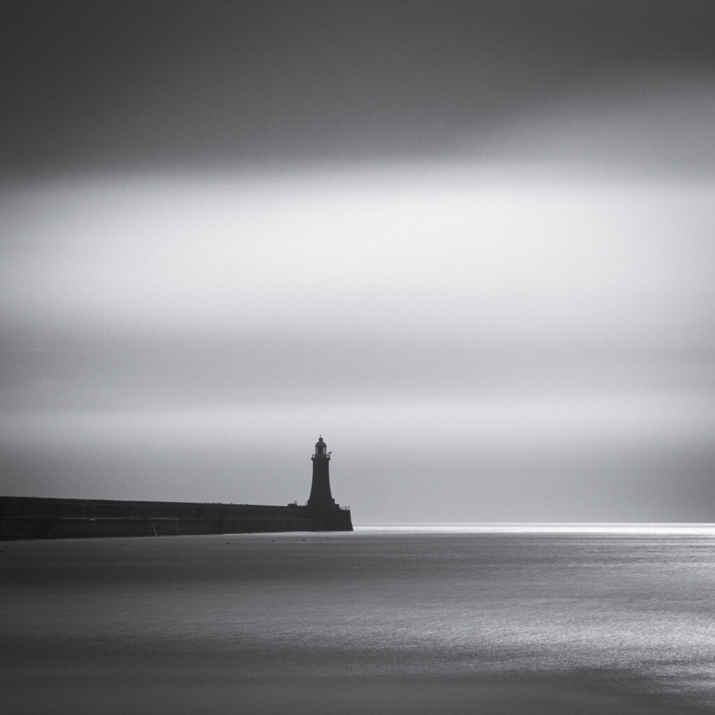 England, Tyne and Wear, Tynemouth. Black & White Long Exposure image of the lighthouse at Tynemouth Pier at the mouth of the River Tyne.