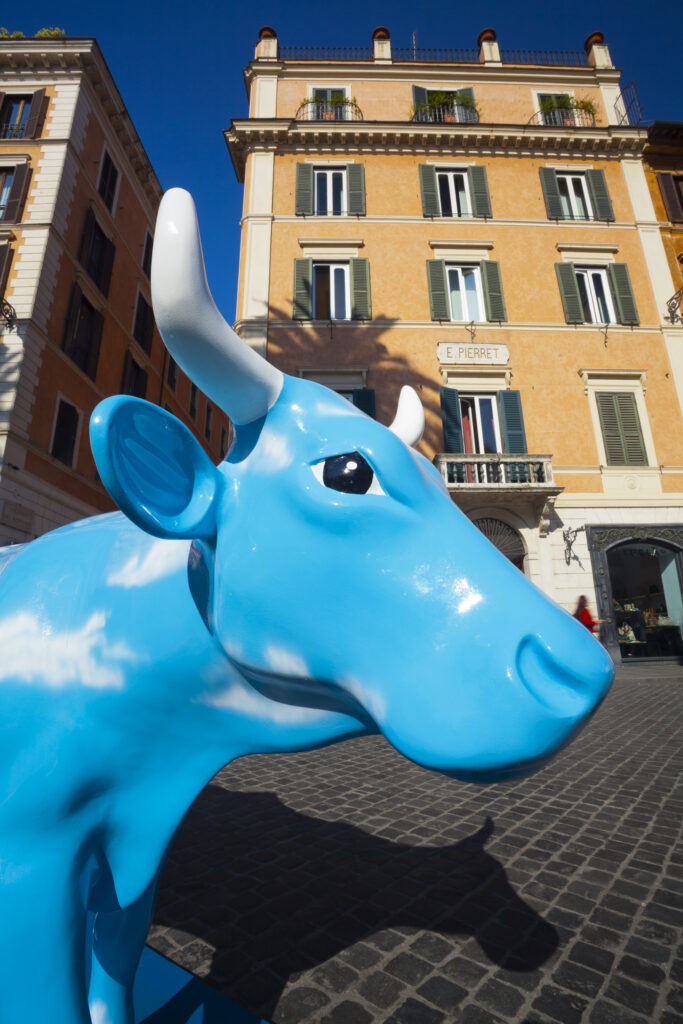 Italy, Lazio, Rome. Street exhbition known as the Cow Parade, on display throughout the city of Rome, here seen near the Spanish Steps in the famous artists' quarter of Rome.