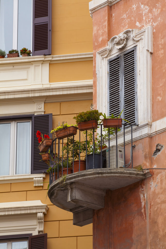 Italy, Lazio, Rome. Plants on a typical Rome residential apartment balcony.