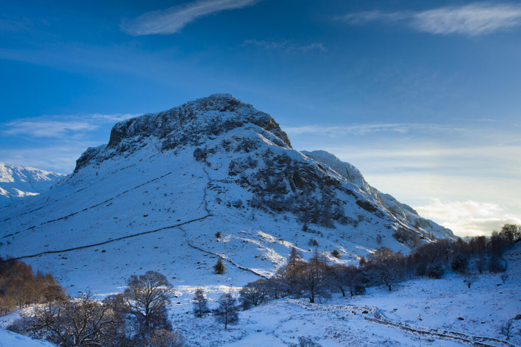 England, Cumbria, The Lake District. The Snow covered Stonethwaite Valley, looking towards Eagle Crag and the Langstrath Valley.