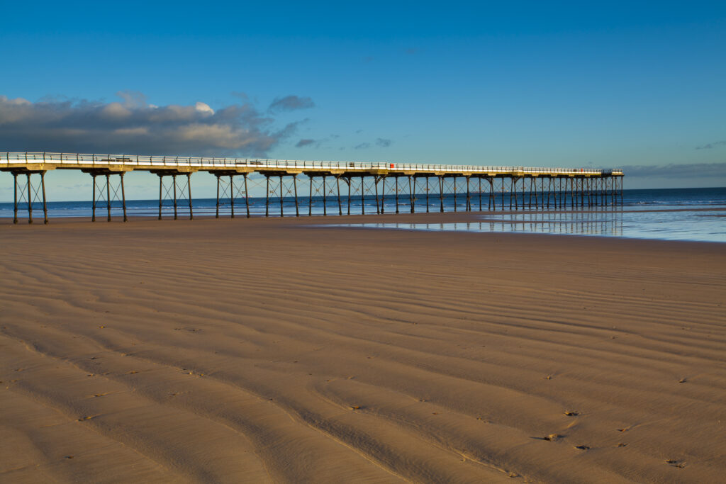 England, Cleveland, Saltburn-by-the-Sea. Looking across the beach. towards the Victorian Pier.