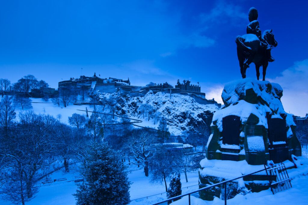 Scotland, Edinburgh, Edinburgh City. Edinburgh Castle and Princes Garden under a blanket of snow.