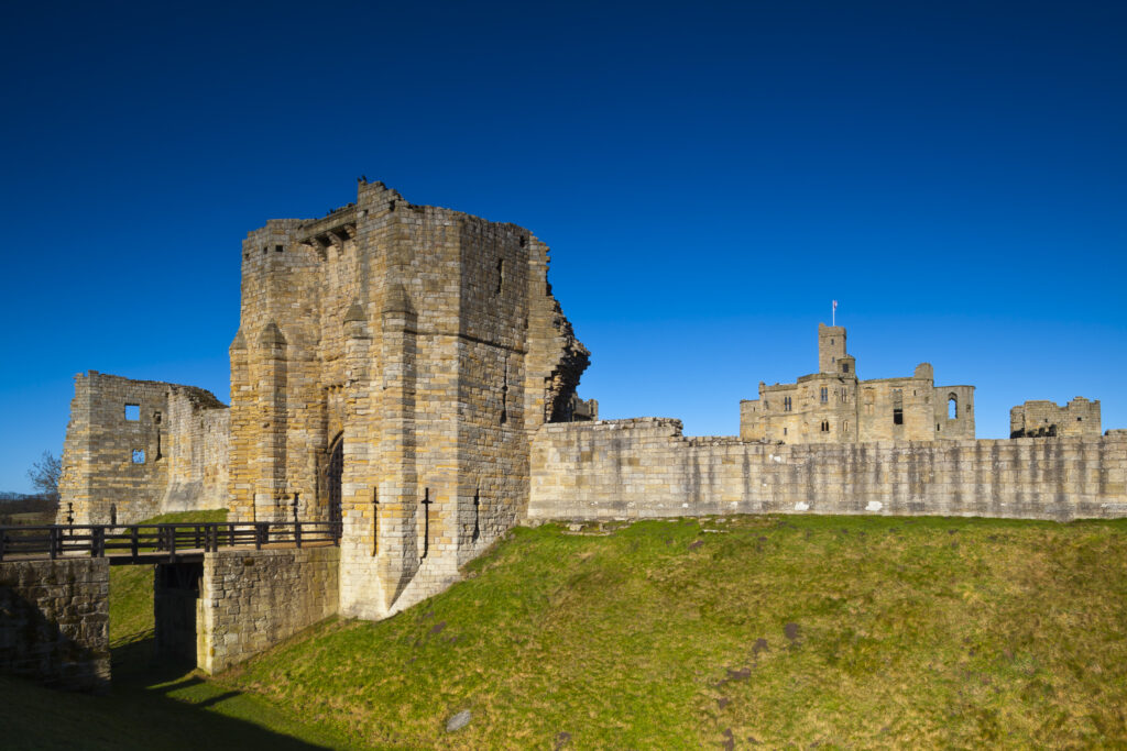 England, Northumberland, Warkworth. Warkworth Castle is a 12th-century stone motte and bailey fortress located near the Northumberland Heritage Coast.