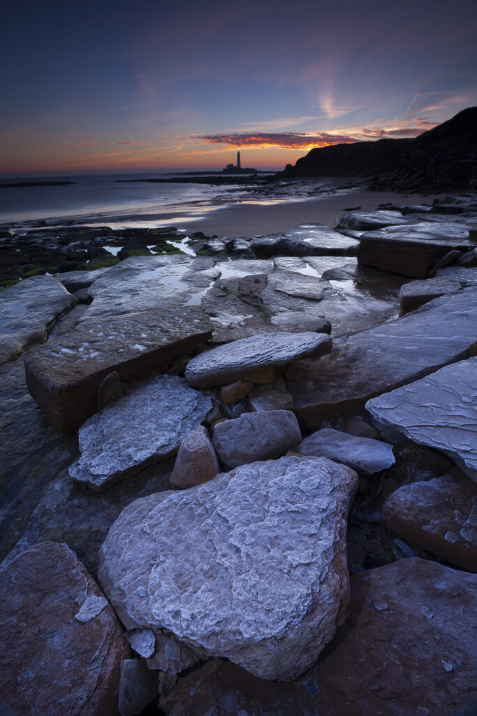 England, Tyne and Wear, Whitley Bay. Frost covered boulder on bay north of St Mary's Lighthouse and Island.