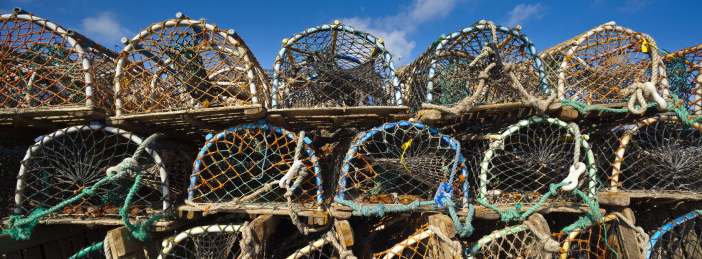 England. Northumberland, Craster. Stack of lobster traps or lobster pots, a portable trap which traps lobsters or crayfish and is used in lobster fishing along the Northumberland Coast.