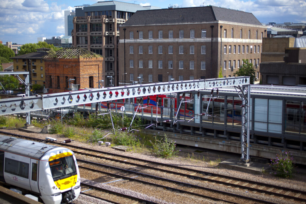 England, Greater London, Pool of London. Tower Gateway DLR station alongside the rail mainline near Tower Bridge.