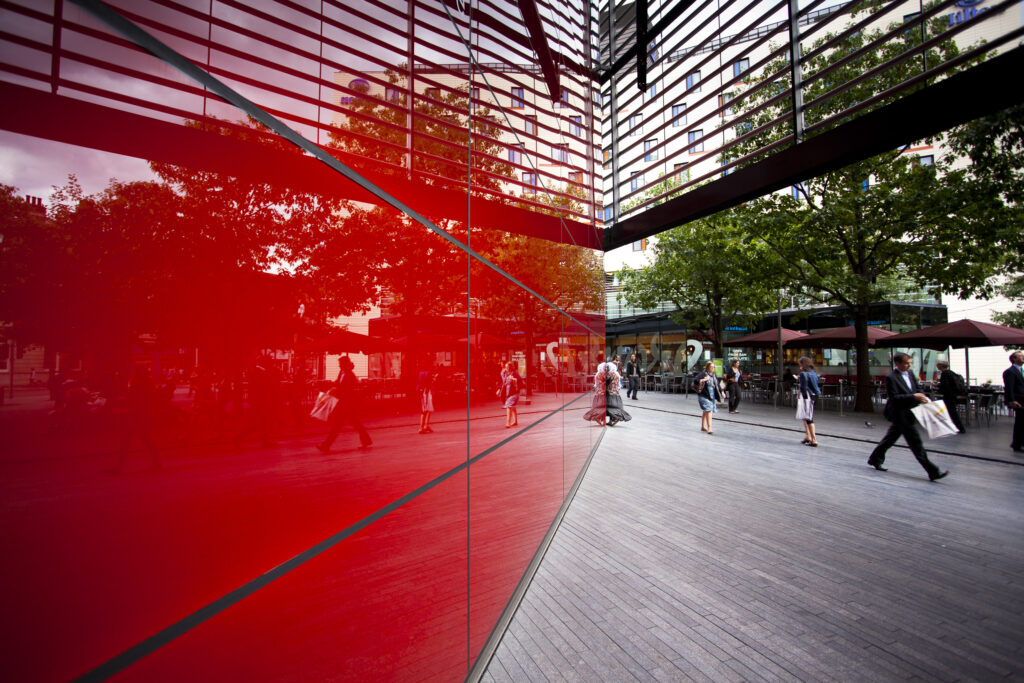 England, Greater London, Southwark. Pedestrians walking past '6 More London Place' office space development near the River Thames.