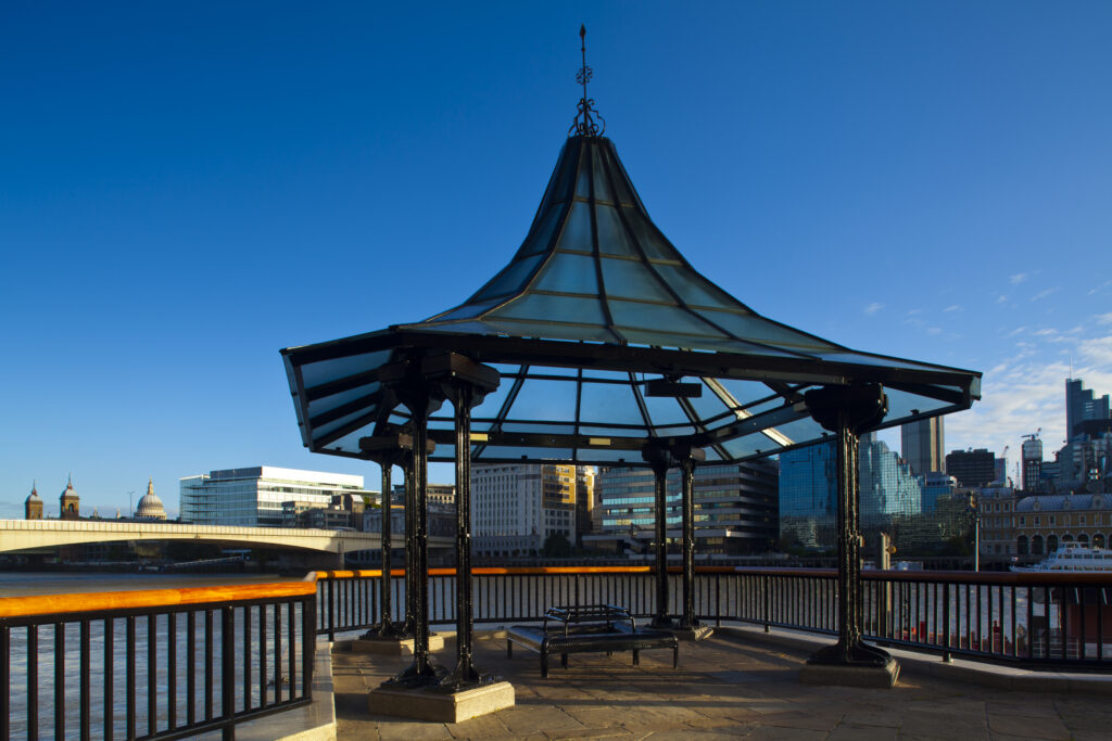 England, London, Southwark. Pavillion on the south bank of the river Thames, with the city of London Financial District and St Pauls Cathedral in the distance.