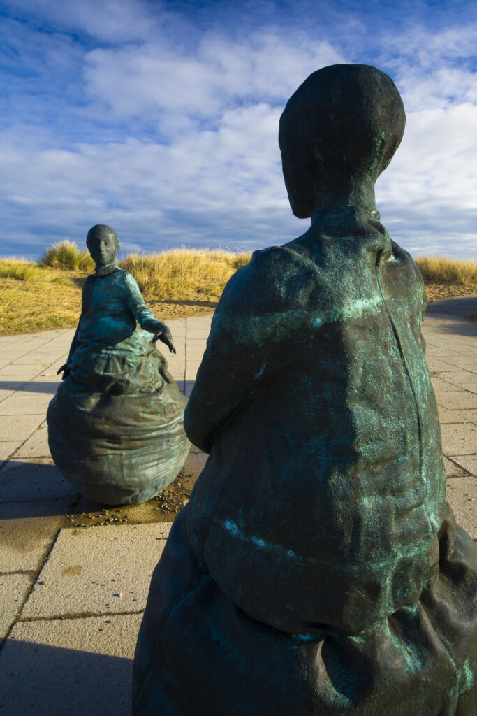 England, Tyne & Wear, South Shields. Bronze statues forming the "Conversation Piece" artwork located near Little haven Beach.