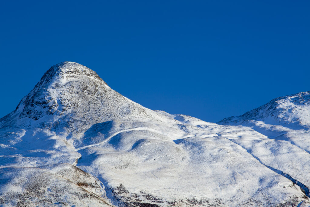 Scotland, Scottish Highlands, Glencoe. The Pap of Glencoe (Sgorr na Ciche) covered in a fresh sprinking of snow.