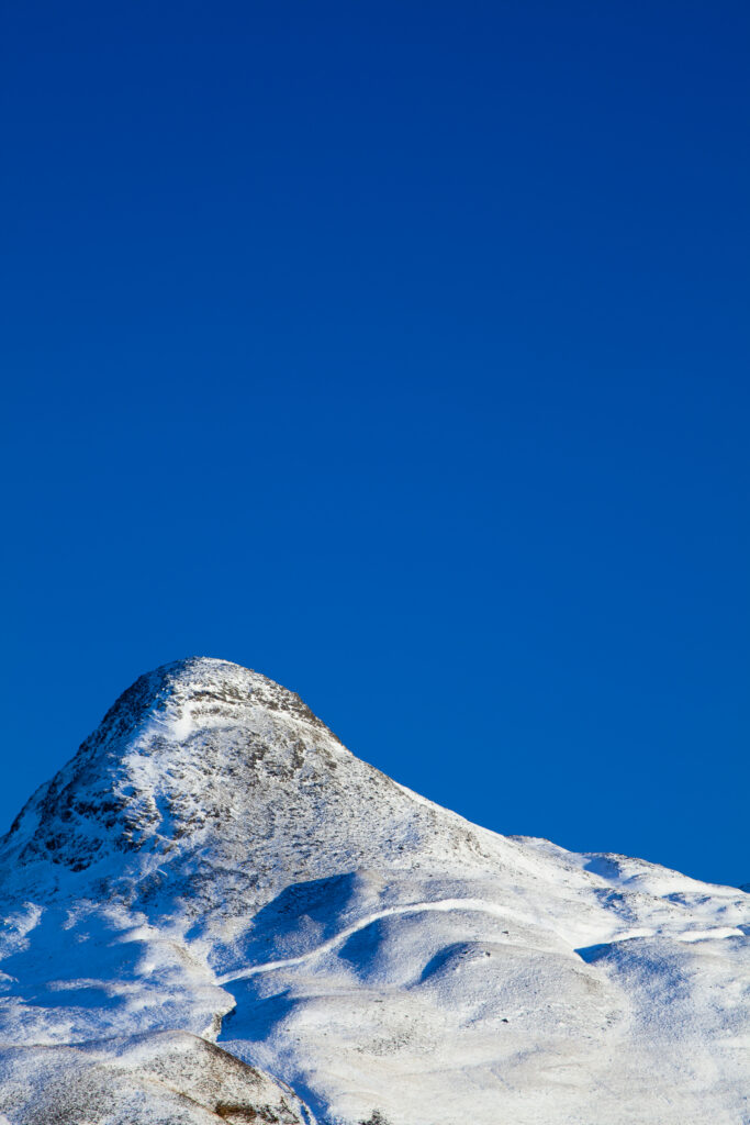Scotland, Scottish Highlands, Glencoe. The Pap of Glencoe (Sgorr na Ciche) covered in a fresh sprinking of snow.