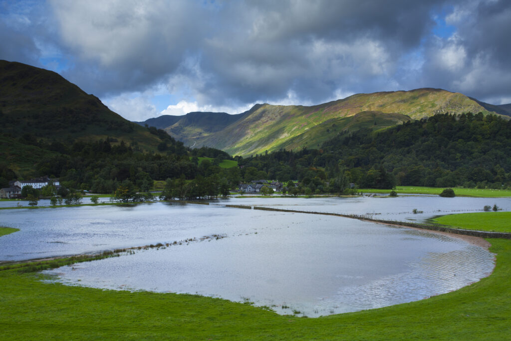 England, Cumbria, Lake District National Park. Floods on farm land near Glenridding in Patterdale, after a prolonged period of heavy rain resulted in the river bursting its banks.