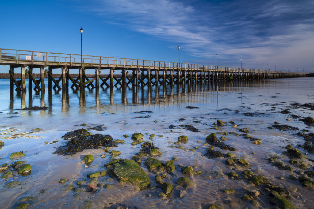 England, Northumberland, Amble. Amble Pier, alongside Amble Harbour. Amble is a small fishing village located along the Northumberland Heritage Coast.