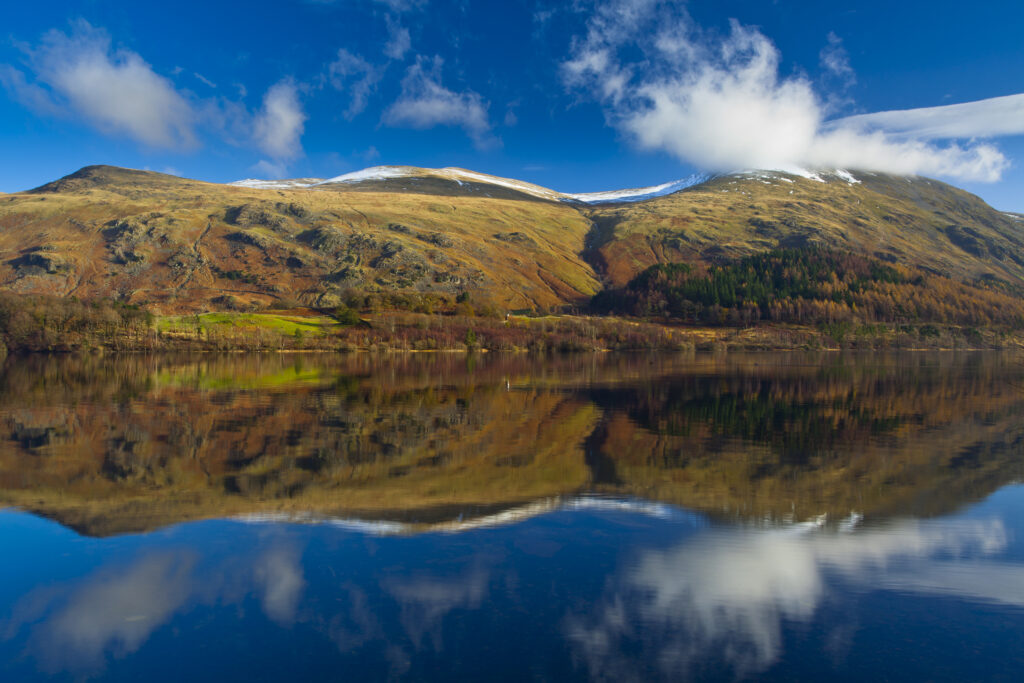 England, Cumbria, Lake District National Park. Lakeland hills reflected upon the still face of the Thirlmere Reservoir