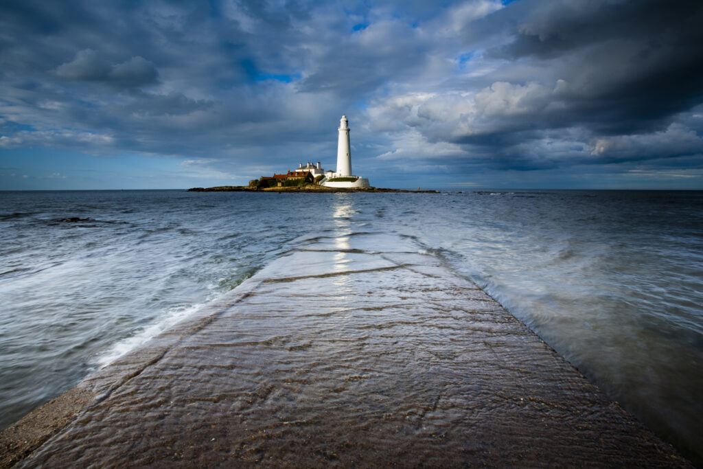 England, Tyne and Wear, Whitley Bay. Incoming tide engulfs the causeway linking St Mary's Island & lifehouse to the mainland..