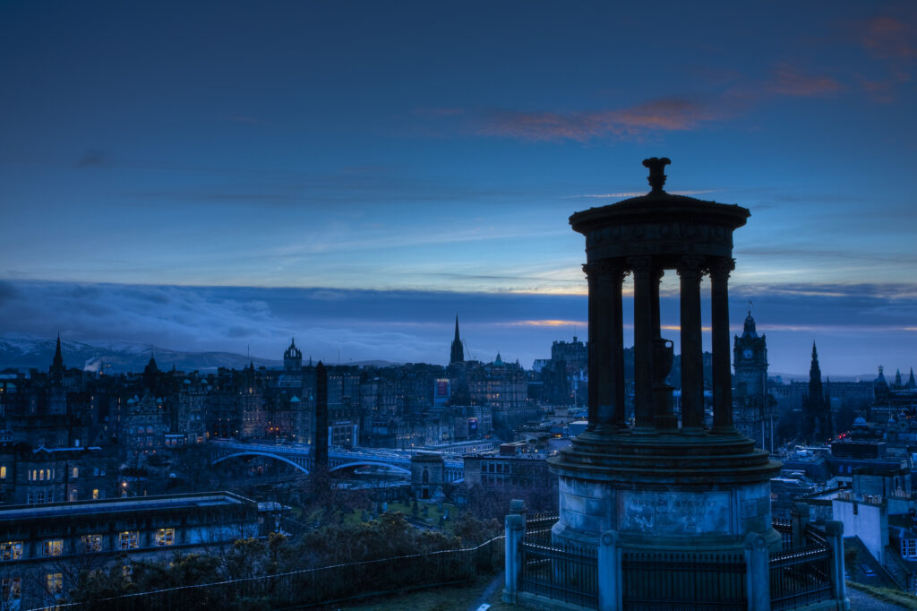 Scotland, Edinburgh, Calton Hill. The Dugald Stewart Monument on Calton Hill, looking towards the Castle and Old Town of Edinburgh.