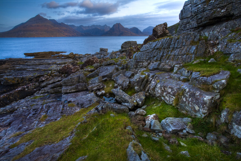 Scotland, Isle Of Skye, Elgol. Looking across the rocky shoreline north of Elgol towards the peaks of the Black Cuillins.