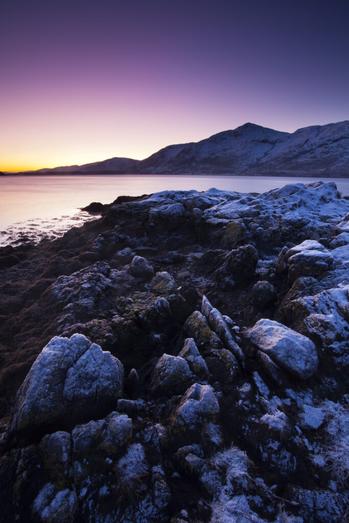 Scotland, Scottish Highlands, Loch Linnhe. Frost covered shoreline of a Loch Linnhe Bay, viewed at dusk.
