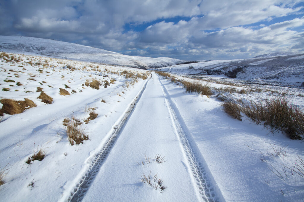 England, Northumberland, Northumberland National Park. Farm tracks running through a fresh snowfall in the Breamish Valley.
