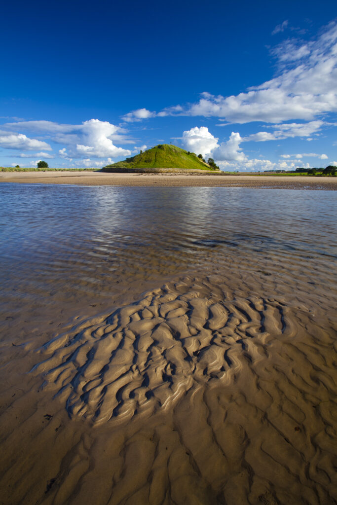 England, Northumberland, Alnmouth. The tidal Aln Estuary at Alnmouth. The hill in the distance is known as Church Hill.
