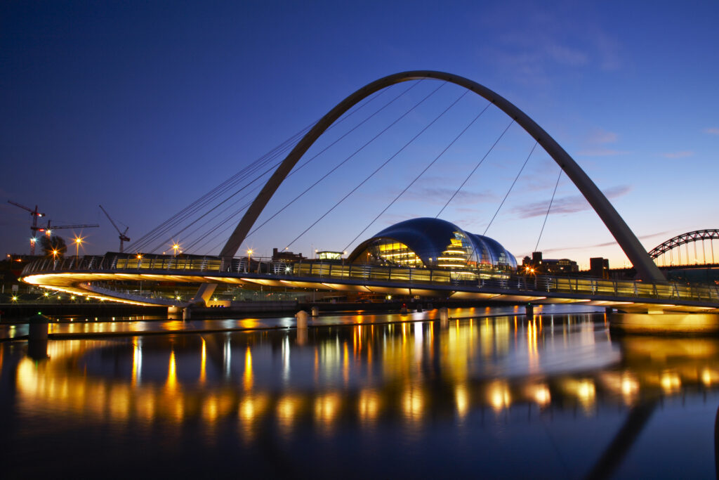 England, Tyne & Wear, Newcastle Upon Tyne. The Millennium Bridge and the river Tyne, viewed at night from the Newcastle upon tyne quayside