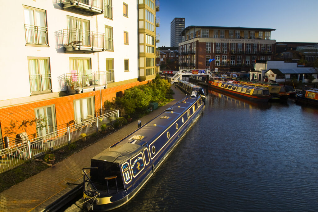 England, West Midlands, Birmingham City. Canal boat moored on King Edwards Wharf.