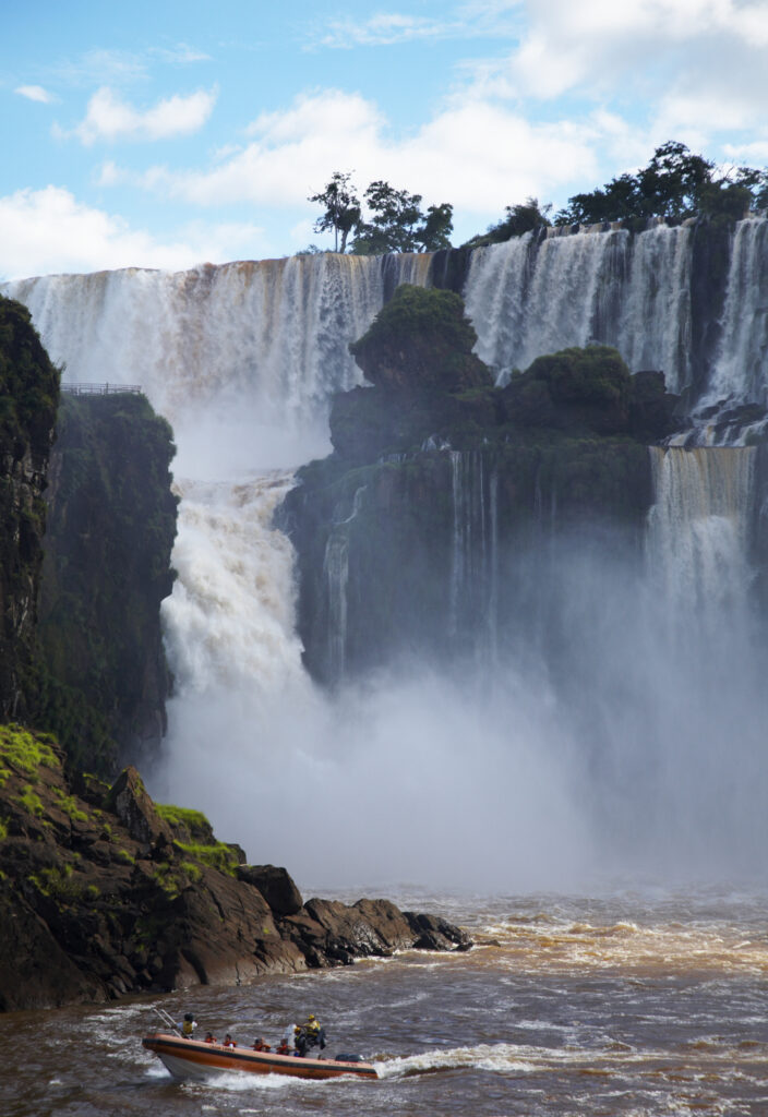 Argentina, Misiones, Iguazu National Park. Tourist boat trip near the impressive Iguazu waterfalls - A world heritage site.