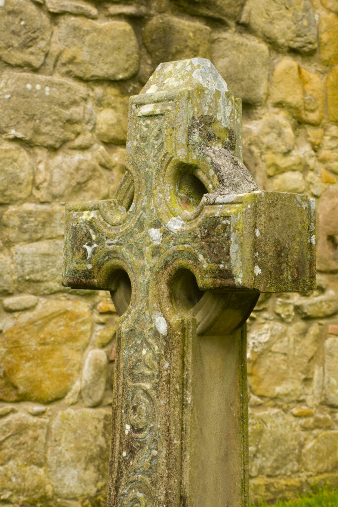 England, Yorkshire, Yorkshire Dales National Park. Celtic design stone cross in the grounds of Bolton Abbey.