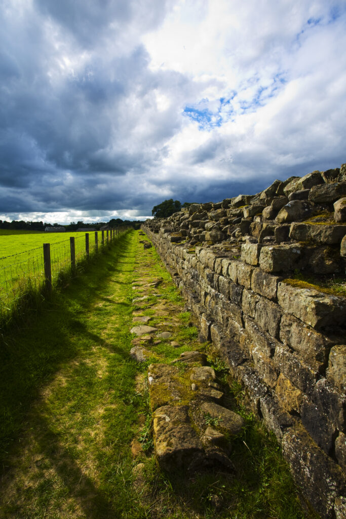 England, Cumbria, Gilsland. Hadrians Wall path running alongside Hadrians Wall - part of the Hadrians Wall UNESCO World Heritage Site.
