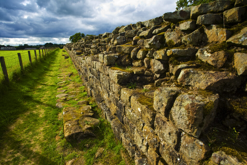 England, Cumbria, Gilsland. Hadrians Wall path running alongside Hadrians Wall - part of the Hadrians Wall UNESCO World Heritage Site.