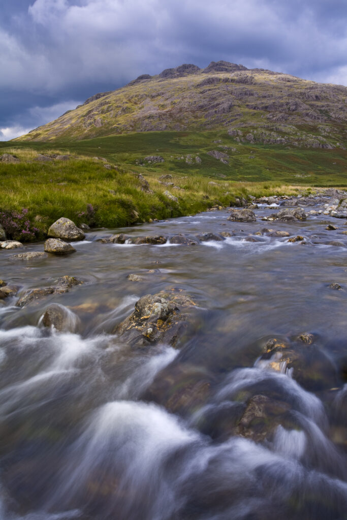 England, Cumbria, Lake District National Park. River Duddon and storm clouds above the Little Stand and Ulpha Fell.