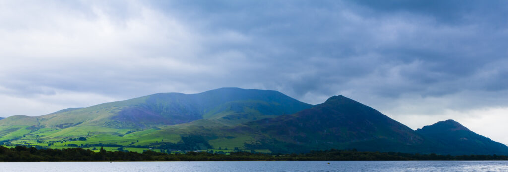 England, Cumbria, Lake District National Park. The domineering landscape of the Skiddaw massif, Englands’ fourth highest mountain at 3053ft, rising steeply from the shores of Bassenthwaite. Bassenthwaite is considered by many to be the only true lake to be found in the Lake District National Park.